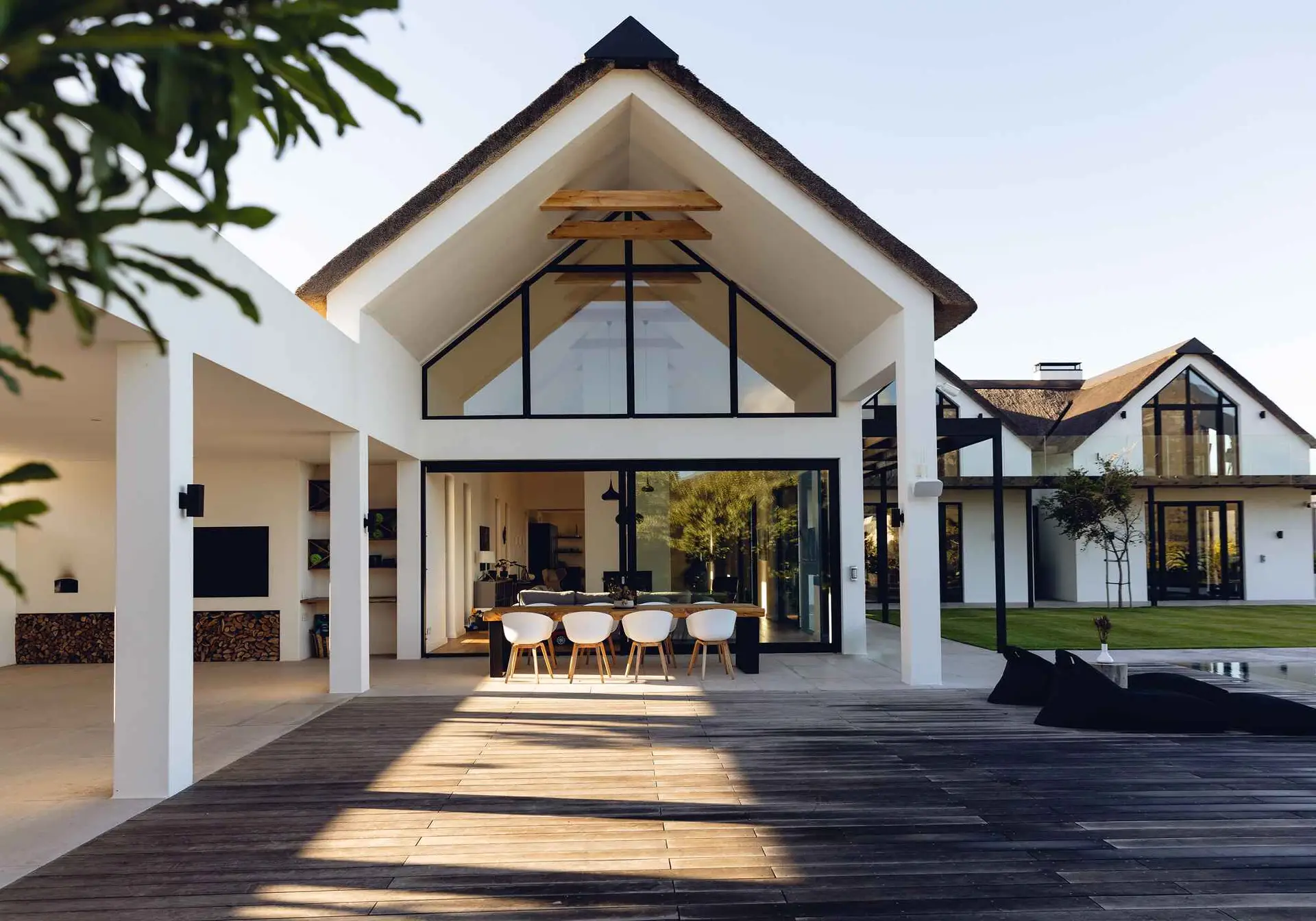 Luxury custom home exterior with covered porch and manicured landscaping